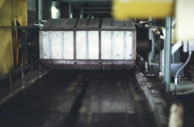 This is a close up view of the discharge end of the Building Panel machine, showing the castings that shape the upper surface of the panels.