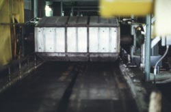 This is an insulated metal building panel with formed edges exiting the Building Panel pressure conveyor.