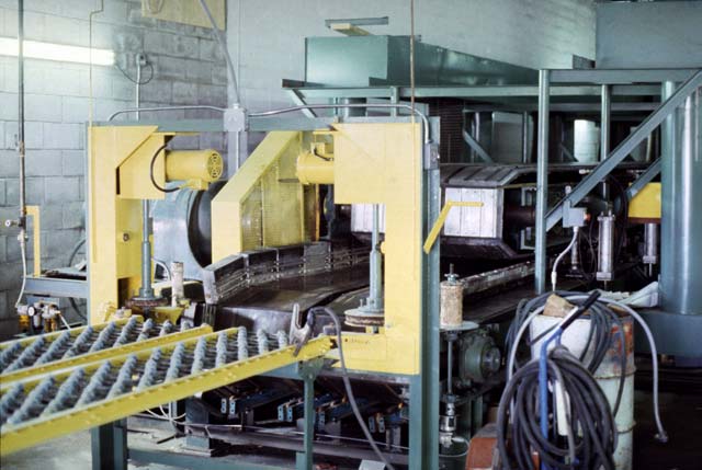 Shown is the discharge end of the same Building Panel machine with additional equipment and 25 years of faithful service.