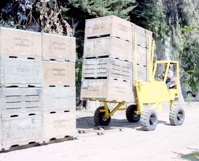 Straddle Fork places 32 picking bins in a row for a quick and easy pick-up by a Strad-O-Lift trailer.