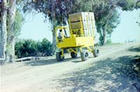 Straddle Fork is a crop harvesting bin transporter with features similar to a forklift.