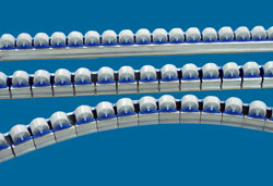 Clicked to enlarge. Curved conveyor rails using lightweight Mini-Wheel gravity sections. Shown here at top is a standard rail, followed by a notched rail, and then a curved rail.