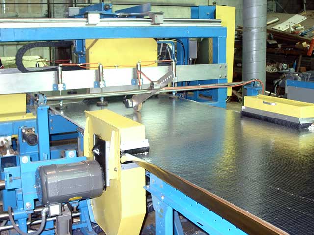 This picture shows the two side trims saws in the foreground and the flying cutoff saw in the middle of a cut in the background.