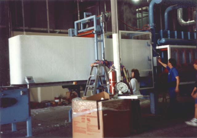 This view shows an extraction of a block of polystyrene out of the molding machine.