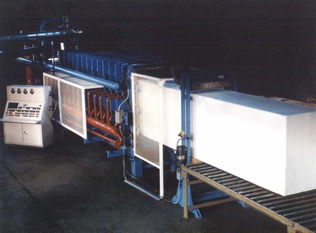 A block of polystyrene is extracted from the molder.